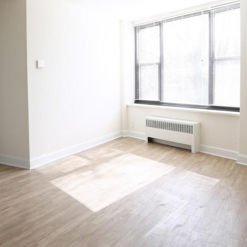a room with a wood floor and a window